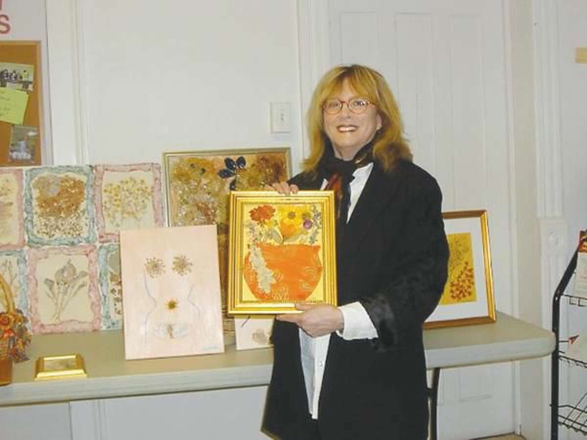 Submitted Photo Lisabeth Billingsley with her pressed flower collages at the Wallingford Garden Club's April 12 meeting.