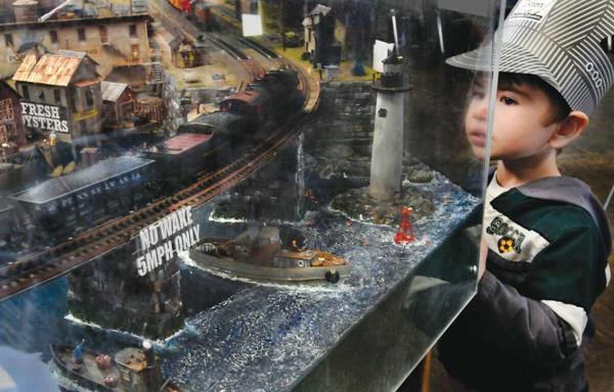 Photo by Melanie Stengel Cameron Parker, 3, of Glastonbury looks over a model railroad display at the model train show at Sheehan High School.