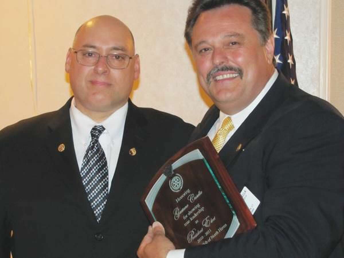 Photo courtesy of David Marchesseault, Rotary Secretary Rotary President Rick DiNorscia (2010-11) honored Presidet-Elect Guy Casella, right, with a placque that read “for showing true leadership” during the president’s personal health crises.