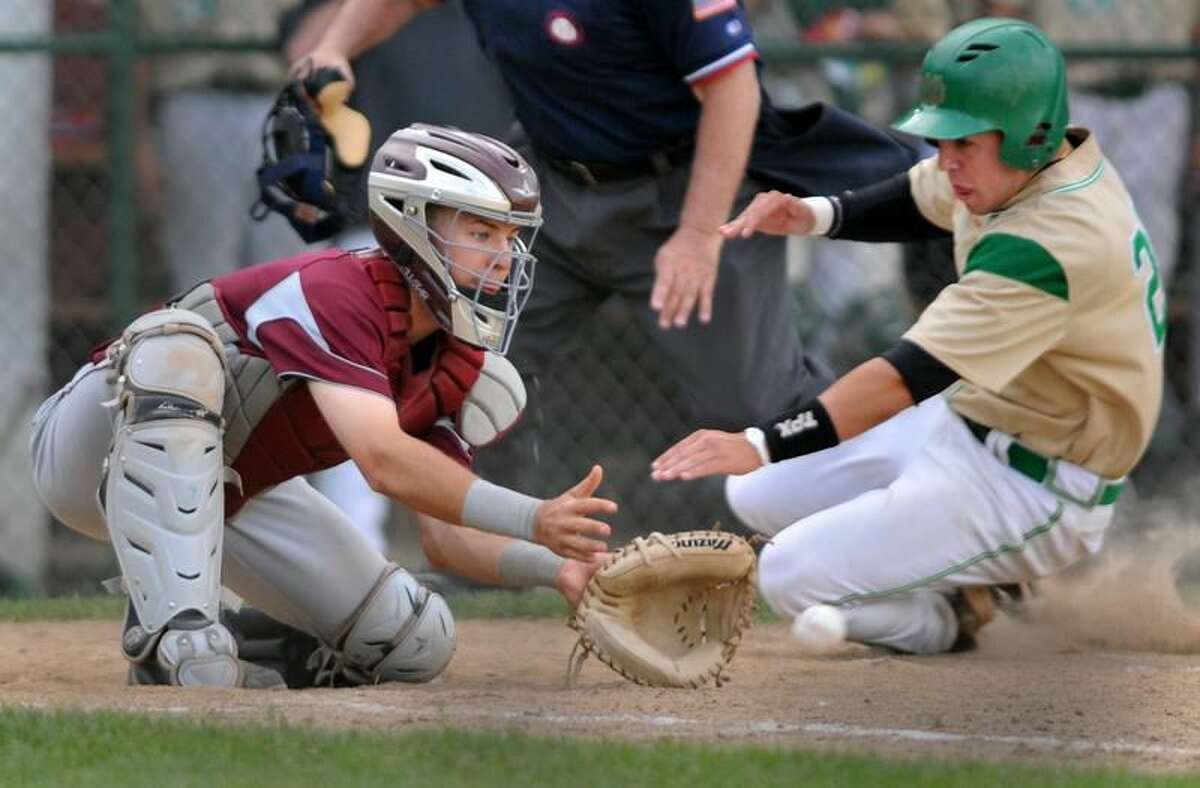 Photo by Brad Horrigan/Register Notre Dame-West Haven's Anthony Masucci slides into home plate ahead of the throw to North Haven catcher Matt Oestreicher during Saturday's Class L quarterfinal game at Cheshire High School. Notre Dame won 9-1.