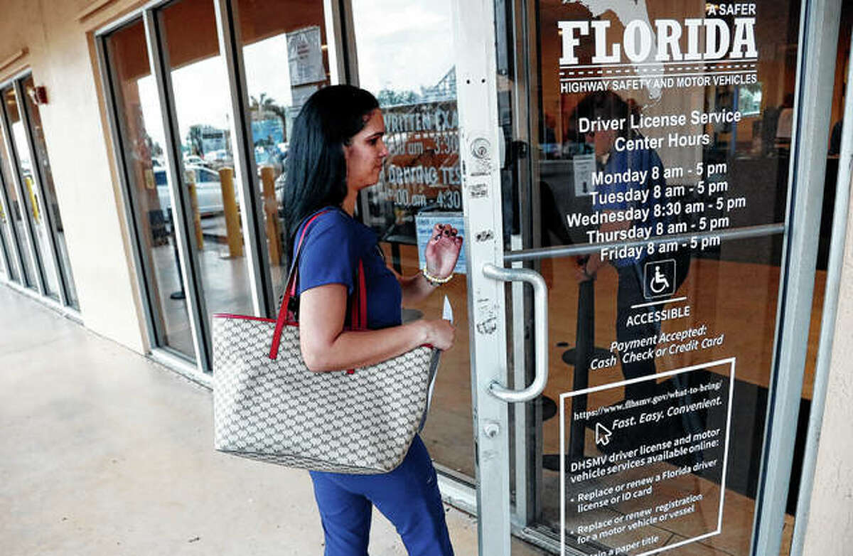 A woman enters a Florida Highway Safety and Motor Vehicles drivers license service center in Hialeah, Florida. The U.S. Census Bureau has asked the 50 states for drivers’ license information, months after President Donald Trump ordered the collection of citizenship information.
