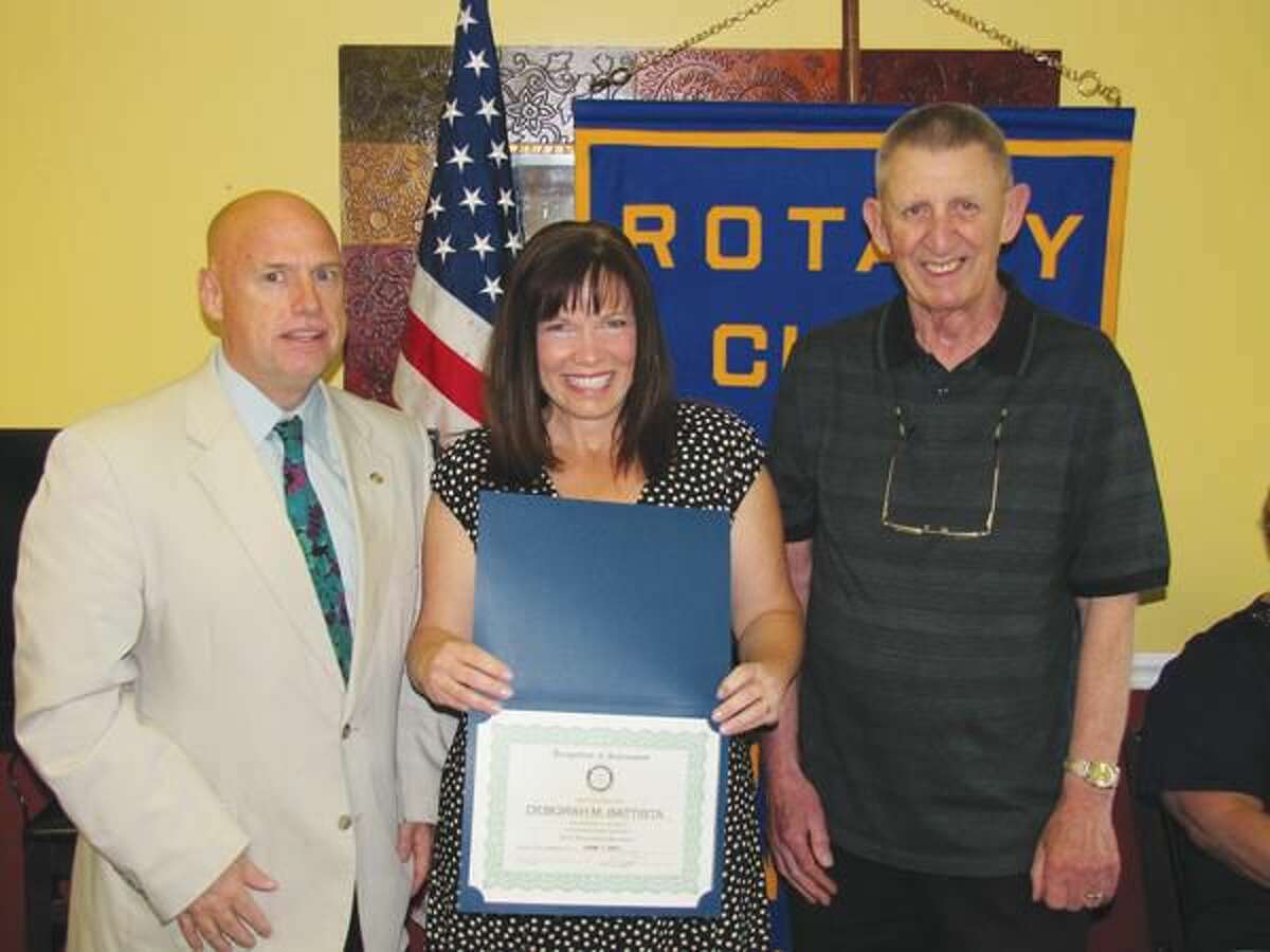 Photo courtesy of David Marchesseault, Rotary Secretary NHR Foundation Chair Rick Bassett, left, and foundation investment manager Hal Ginter congratulate Debbie Battista.