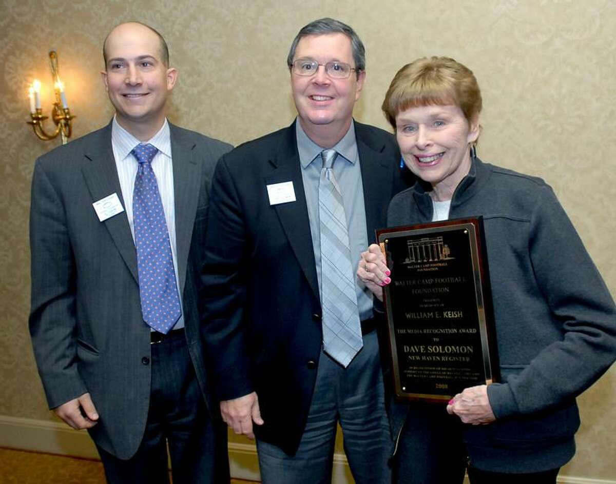 File photo by Arnold Gold/Register Dave Solomon, center, accepted the Keish Media Appreciation Award from the Walter Camp Foundation in 2009, presented by Al Carbone, left, and Doris Keish.