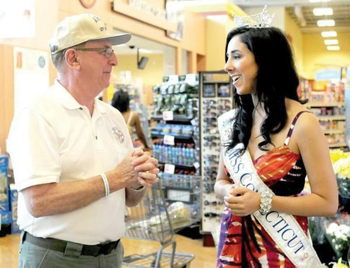 Photo by Peter Hvizdak Alton Hudson of North Haven, 70, a 23-year veteran of the U.S. Air Force, left, and Miss Connecticut, Morgan Amarone of North Haven, chat during a fundraising effort at Shop Rite in Hamden Saturday for Fisher House of Connecticut. The housing will be built at the VA hospital in West Haven for veterans families.