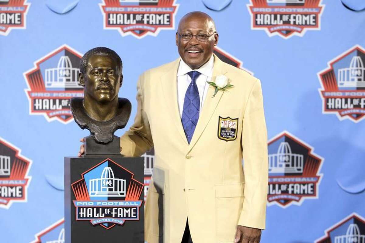 Floyd Little poses with his bust after enshrinement in the Pro Football Hall of Fame in Canton, Ohio Saturday, Aug. 7, 2010. (AP Photo/Mark Duncan)