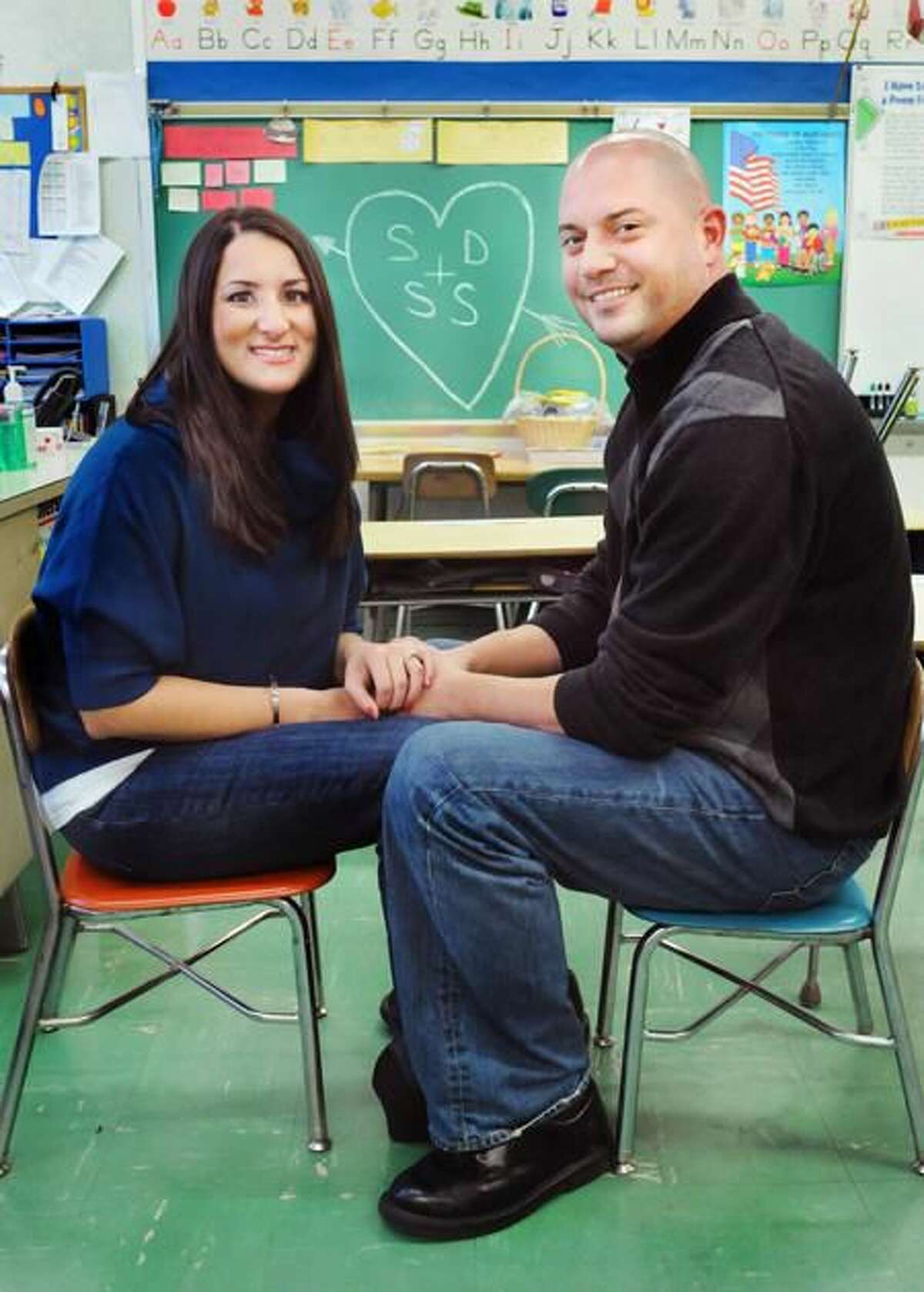 Samantha Sampiere, left, and Steven Dobson have their engagement photos taken at Bradley School in Derby where they first attended classes together. Melanie Stengel/Register