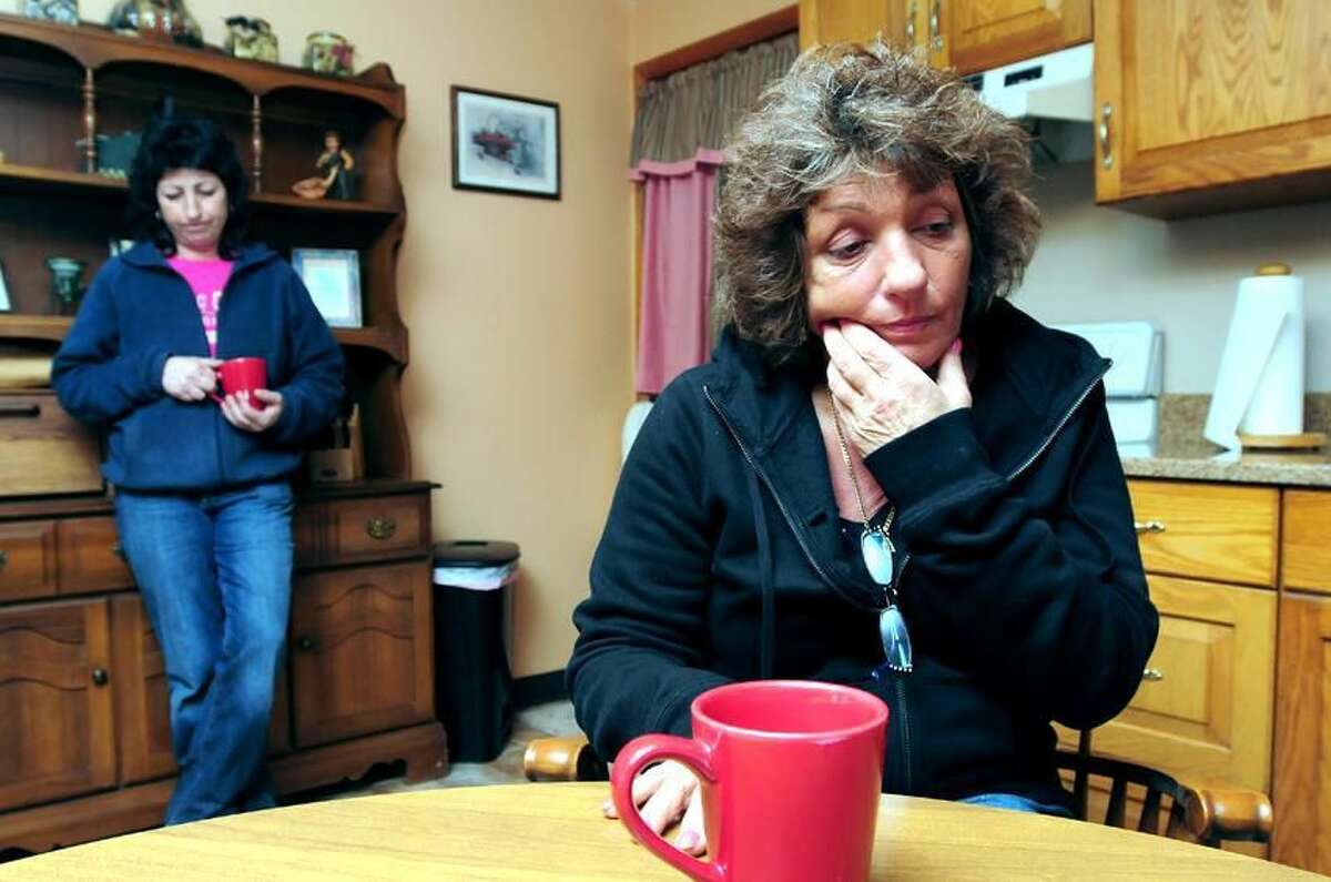 Donna Lee, right, talks about the disappearance of her daughter, Doreen Vincent, in 1988 at her home in Waterbury recently. At left is her sister, Debbie Pereira. Arnold Gold/Register
