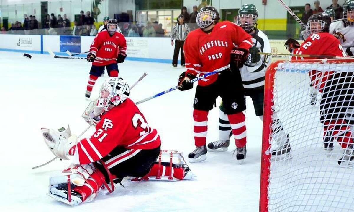 Fairfield Prep goalie Riley Wikman (left) of Fairfield Prep blocks a shot against Hamden in the first period on 12/25/2012. Photo by Arnold Gold/New Haven Register