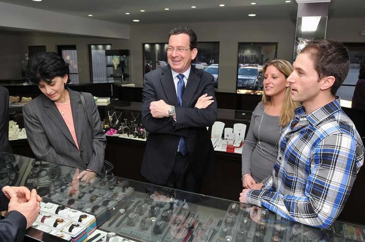 Gov. Dannel P. Malloy, center, laughs as he visits Rumanoff's Fine Jewelry in Hamden prior to a Chamber of Commerce dinner at DeMil's Restaurant. On the left is SCSU President Mary A. Papazian and on the right is Doug and Leslie Rumanoff. Peter Casolino/Register