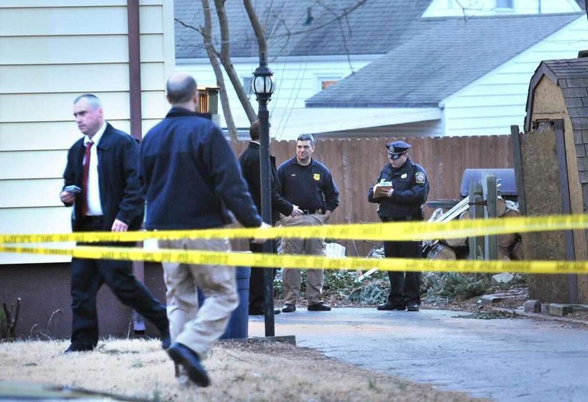 Hamden police investigate behind the house at 388 Wooden St. after a woman's body was found by the homeowner there. Peter Casolino/Register