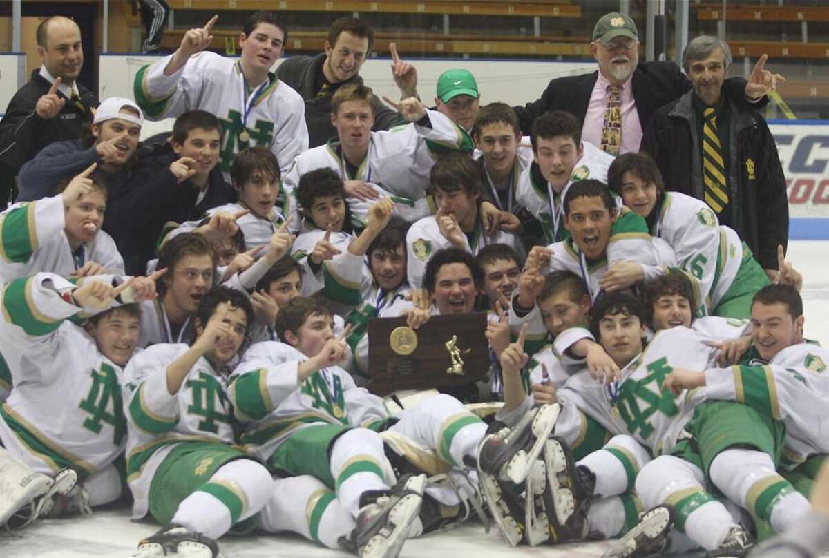 Photo by Russ McCreven The Notre Dame-West Haven hockey team celebrates the Division I hockey championship. The Green Knights finished No. 1 in the final New Haven Register Top 10 poll.