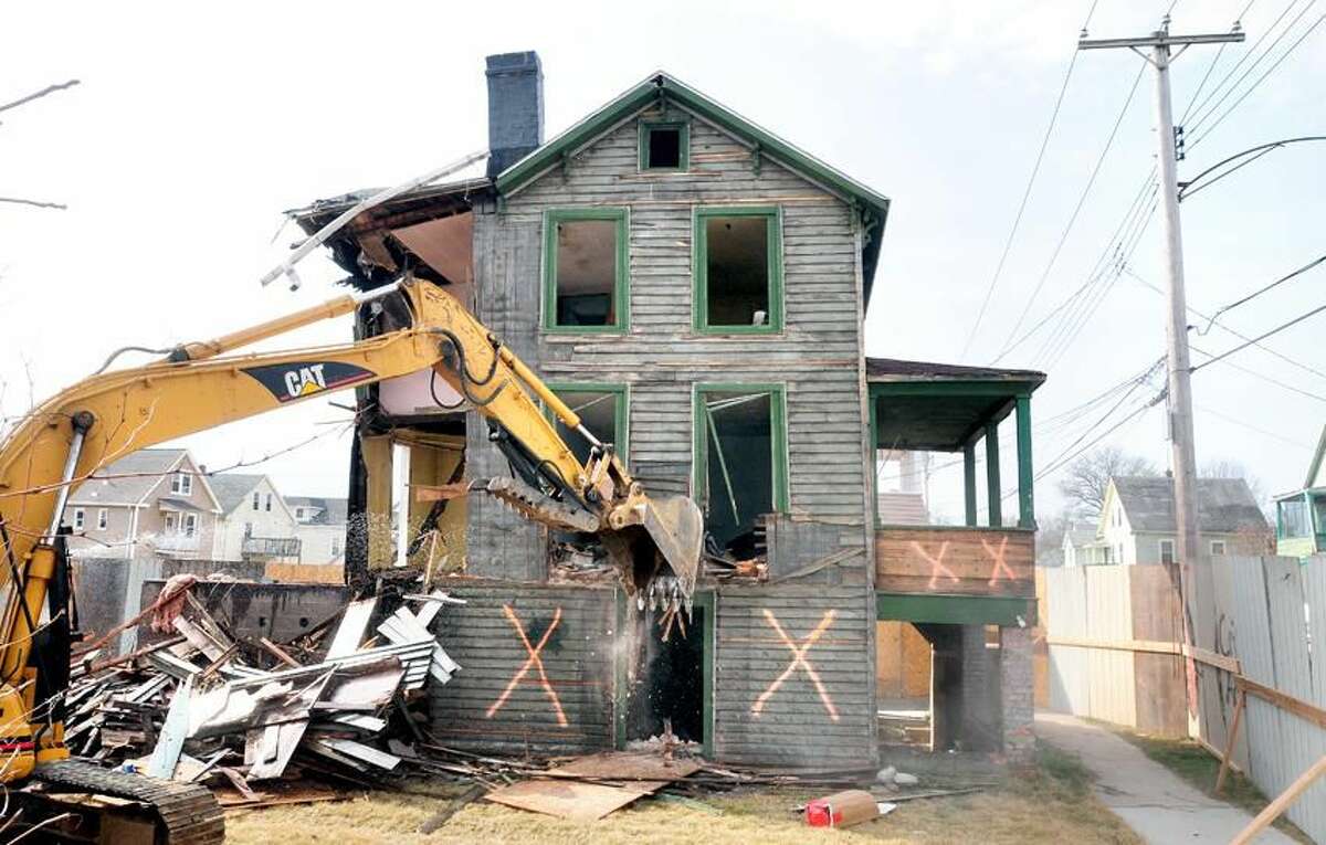 A house at 59 Edwards St. in Hamden is demolished on 3/23/2012 as part of a Hamden Economic Development Corporation remediation project.Photo by Arnold Gold/New Haven Register AG0444D