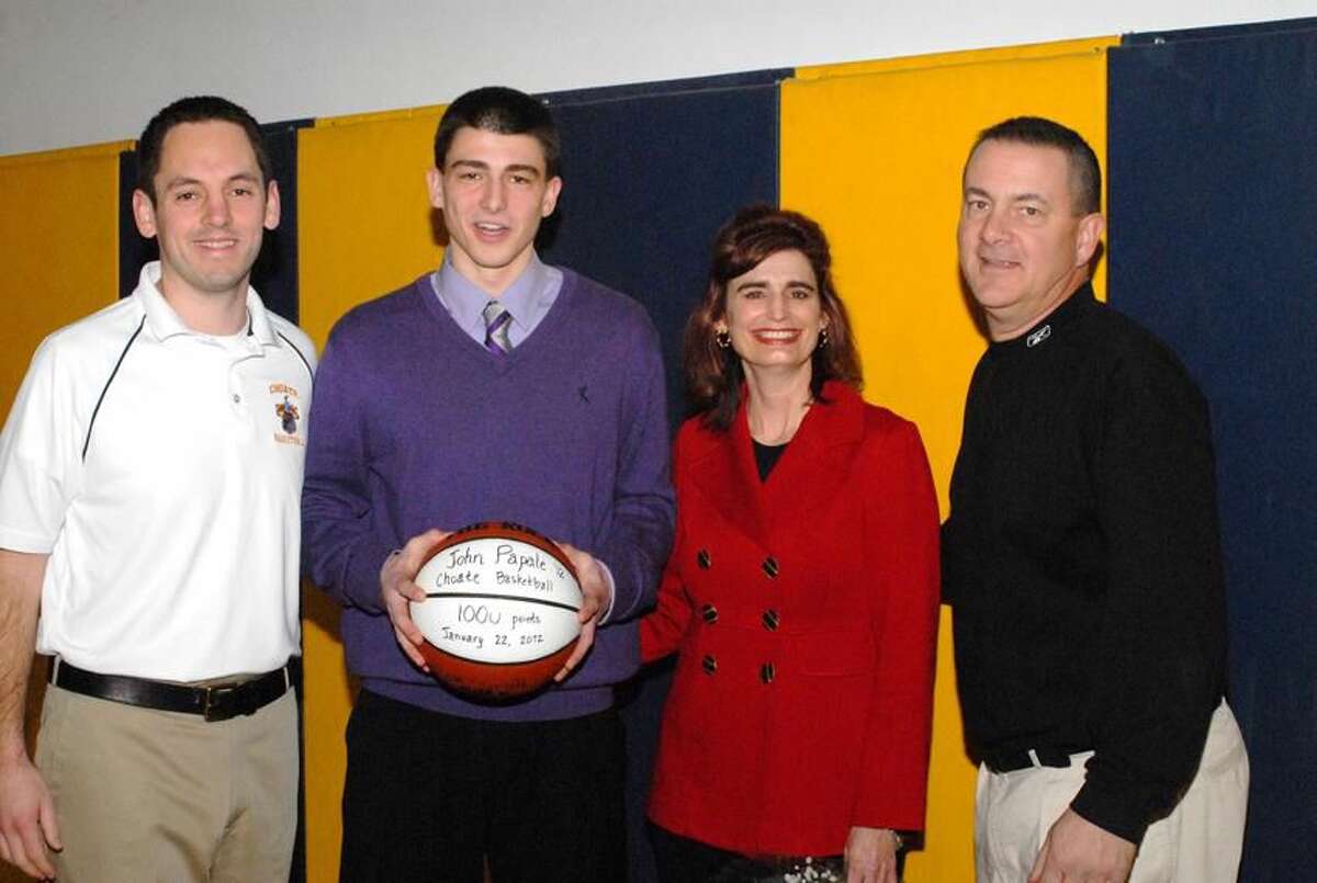 Photo by Bill O'Brien Choate senior John Papale, of Wallingford, was honored before a recent game against Cheshire Academy. Papale, pictured with coach Adam Finklestein and parents Joan and Mike, is the school's all-time leading scorer with 1,153 points. He will attend Boston University in the fall.