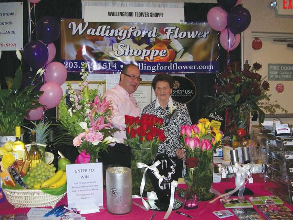 Photo by Lynn Fredricksen Sal and Ann Greco of Wallingford Flower Shop display some of their wares at the Quinnipiac Chamber of Commerce Expo 2012 at the Holiday Inn in North Haven.