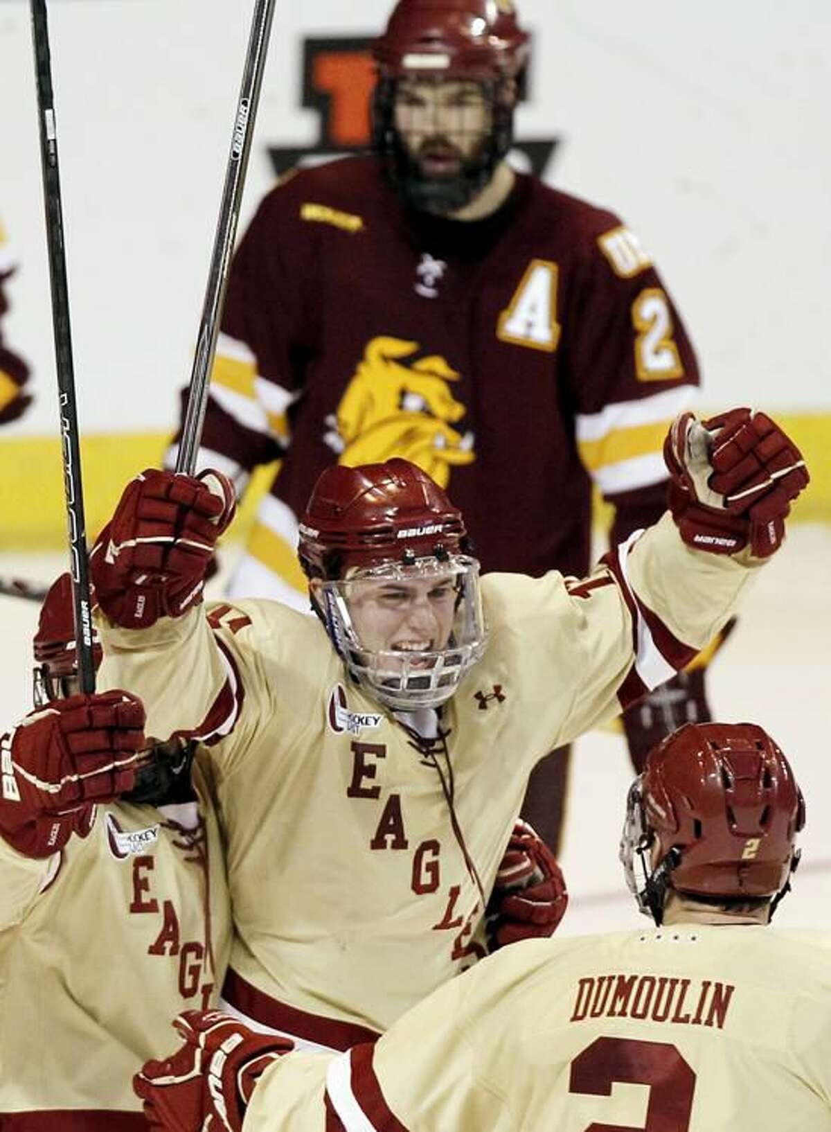 Boston College's Pat Mullane celebrates his goal as Minnesota-Duluth's Brady Lamb (2) looks on during the second period of an NCAA Northeast Regional Final college hockey game in Worcester, Mass., Sunday, March 25, 2012. (AP Photo/Winslow Townson)