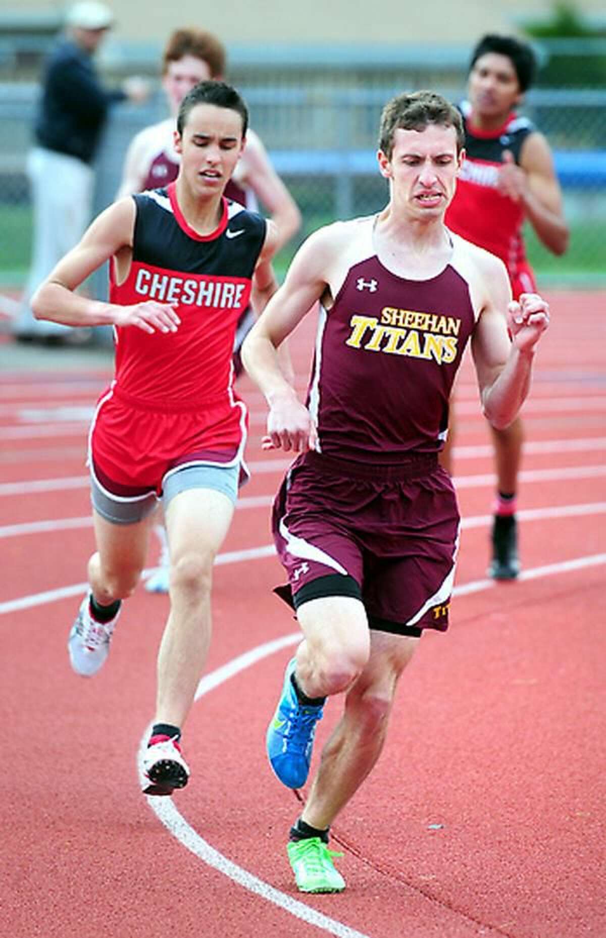 Tommy Lupoli (right) of Sheehan leads in the final lap of the 1600 meter run with Trey Phillips (left) of Cheshire close behind in a meet at Cheshire on 4/24/2012. Photo by Arnold Gold/New Haven Register