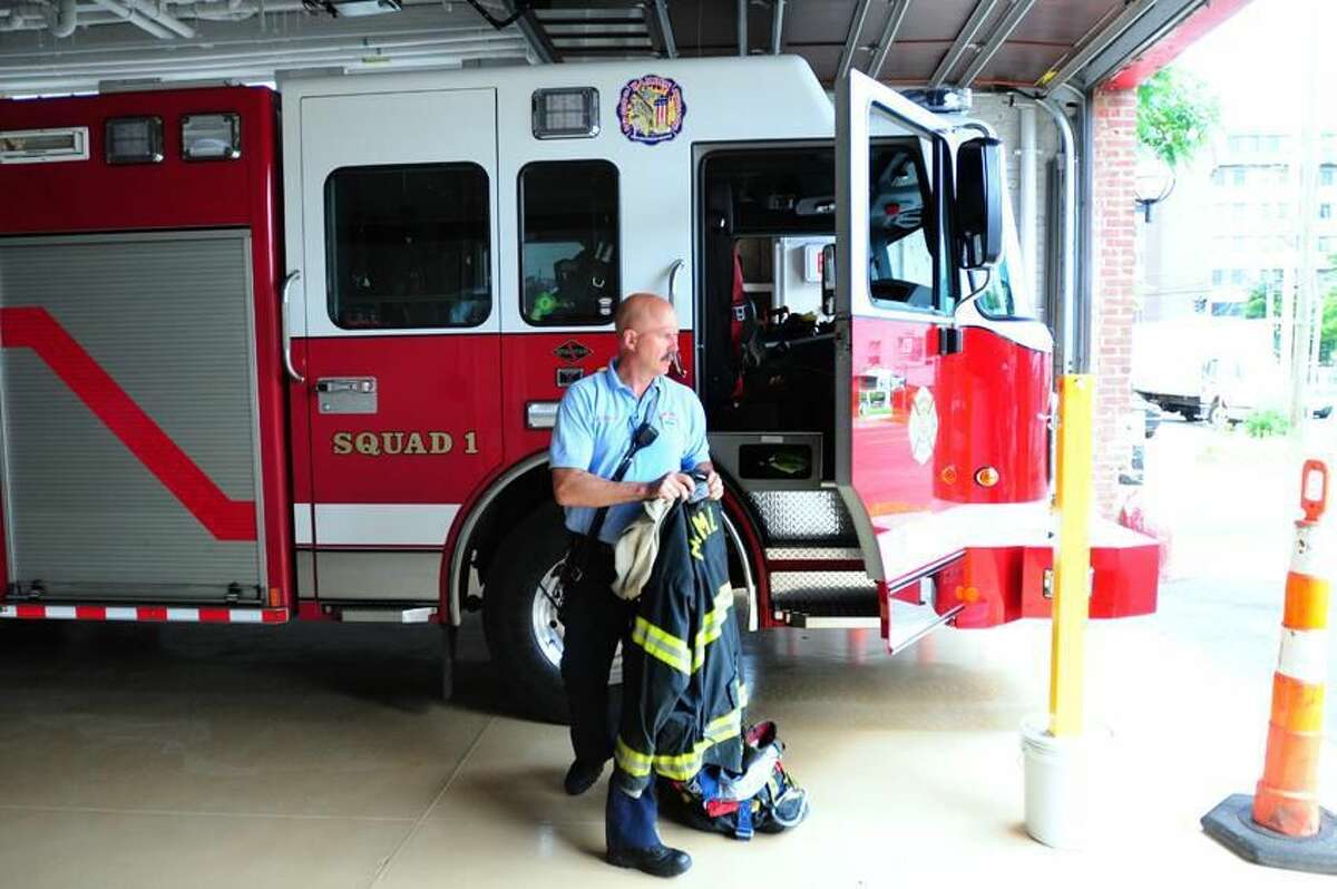 Lt. Gary Merwede unloads his turnout gear at the renovated fire station at Memorial Town Hall in Hamden on 6/18/2012. Photo by Arnold Gold/New Haven Register