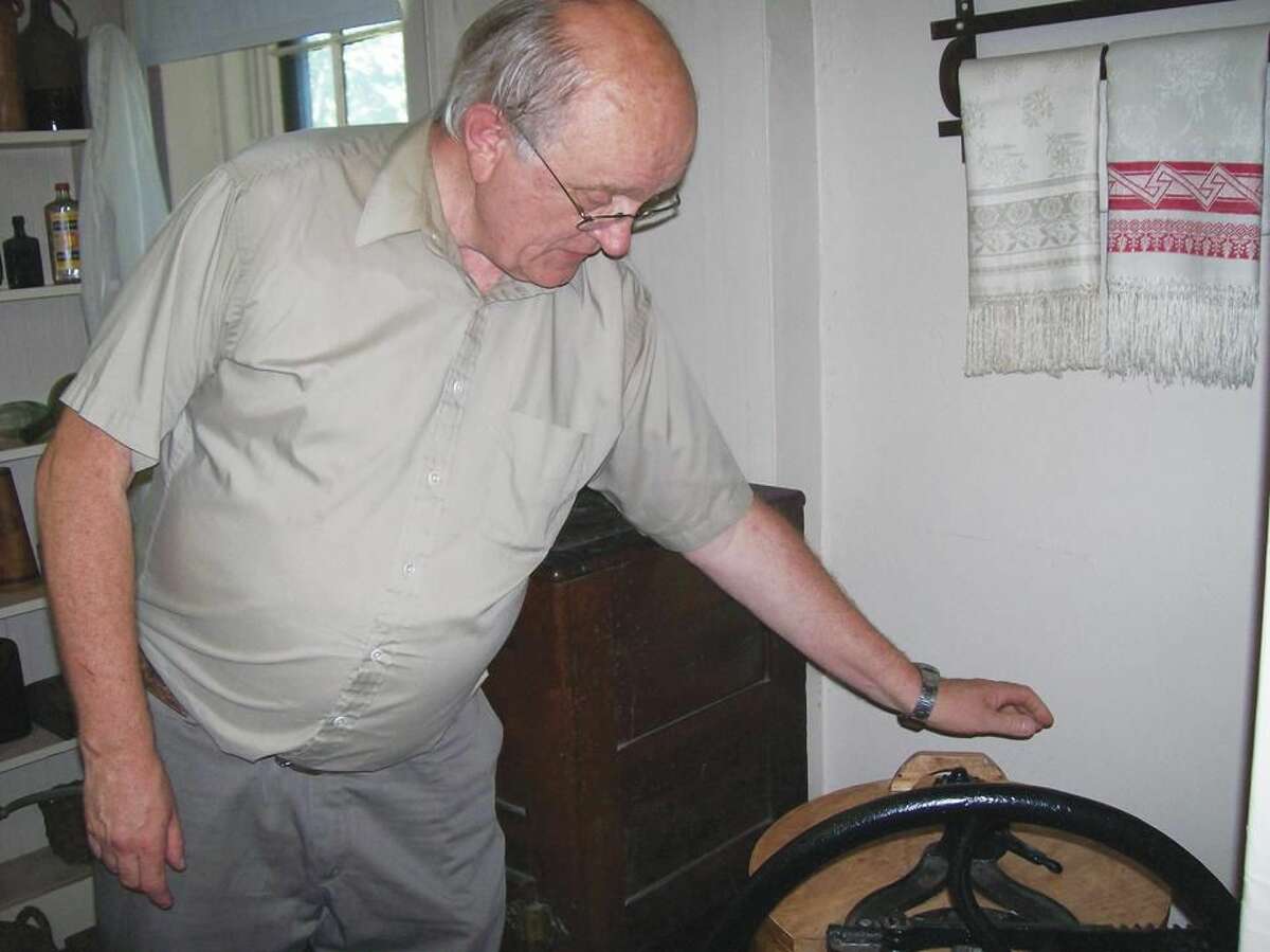 Bob Iverson, president of the North Haven Historical Society, explains the features of a very early washing machine on display at the Martha Culver House on Quinnipiac Avenue. The house was open for tours on Sunday as part of an open house event presented by the Historical Society.