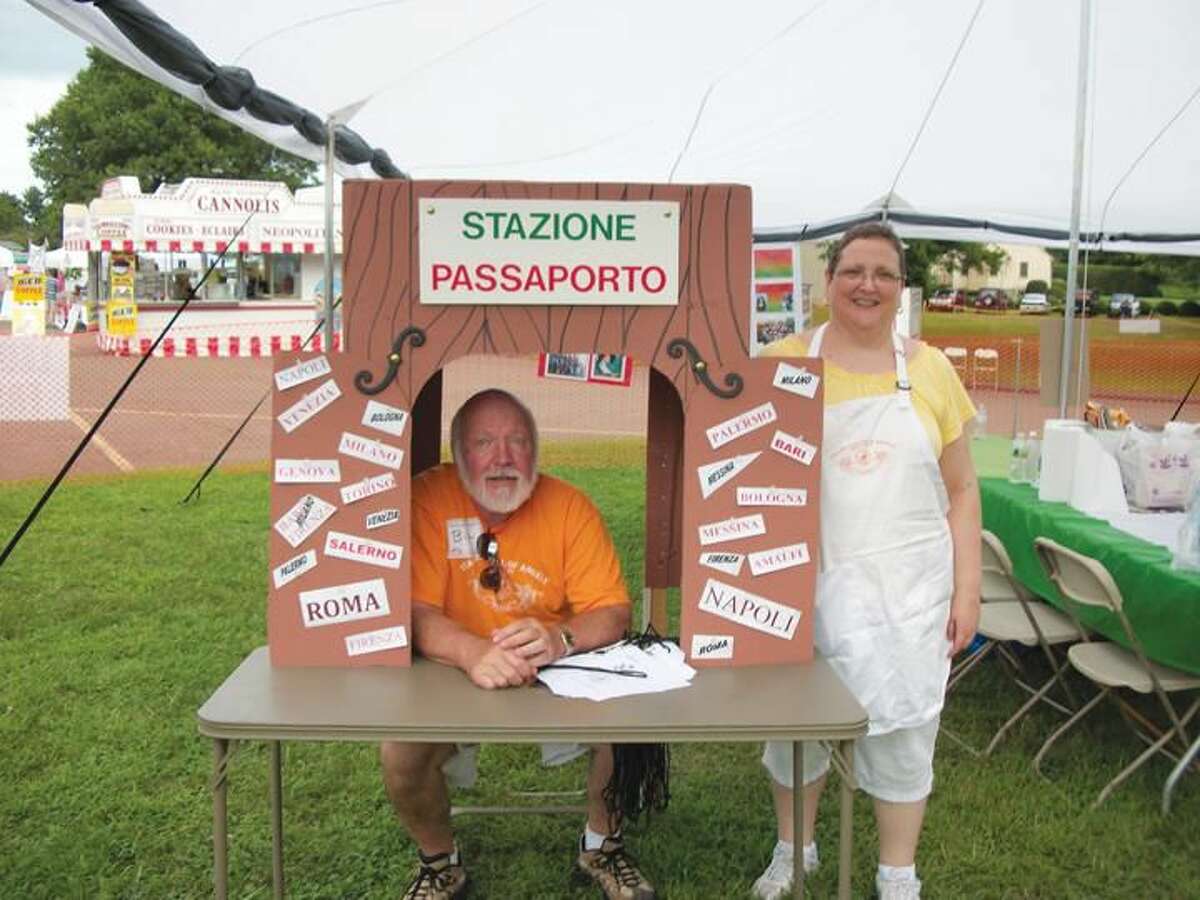 Photo by Lynn Fredricksen Bill Lewis volunteered to man the passport booth in the Kids’ Zone at the eighth annual Italian Festival of Angels held last weekend on the grounds of St. Therese Church on Middletown Avenue. He is pictured with Theresa Marino, another member of the Festival Committee.