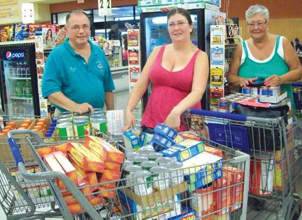 Submitted Photo Shown are Lodge Members Andrew Caporossi, Jen Caputo and Kathy Kelsey purchasing groceries for the Hamden Food Bank.