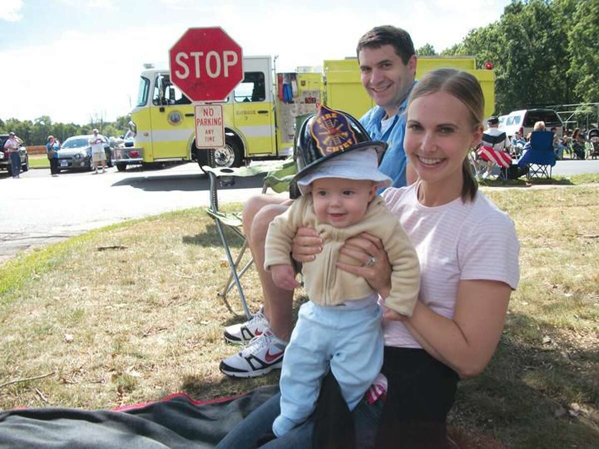 Alexander Smoot, 4 months, was perhaps the youngest fan to watch the firefighters parade on Sunday. He is pictured with his parents, Erica and Nicholas, all of North Haven.