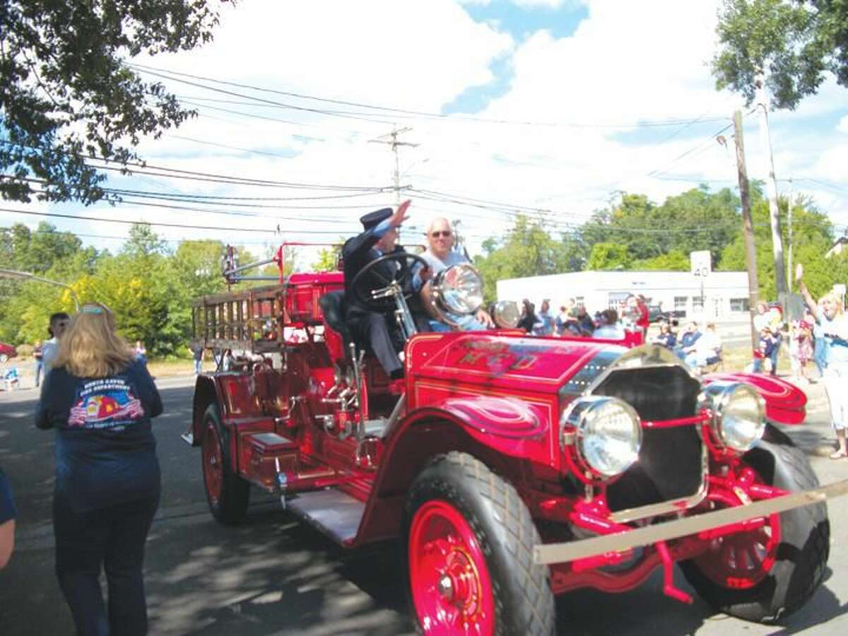 Photo by Lynn Fredricksen Members of the Phoenix Engine Co. had their old ride all decked out for the 129th annual Connecticut State Firefighters Association Parade on Sunday.