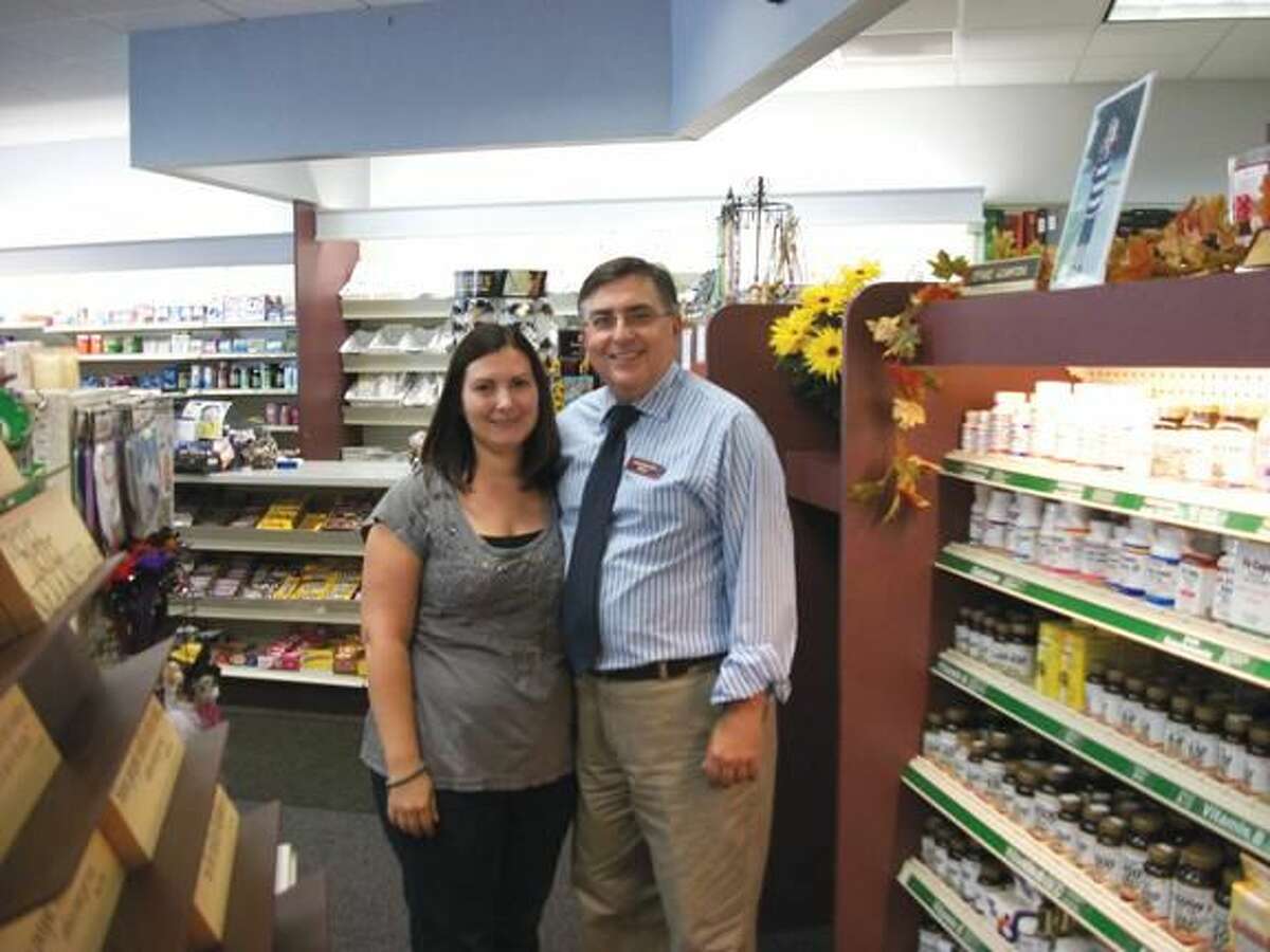 Photo by Lynn Fredricksen North Haven Pharmacy owner Gerald Acampora and his daughter, Stephanie Hryb share a father-daughter moment. The pharmacy, family owned and operated since the mid-1960s is located at 278 Maple Ave.