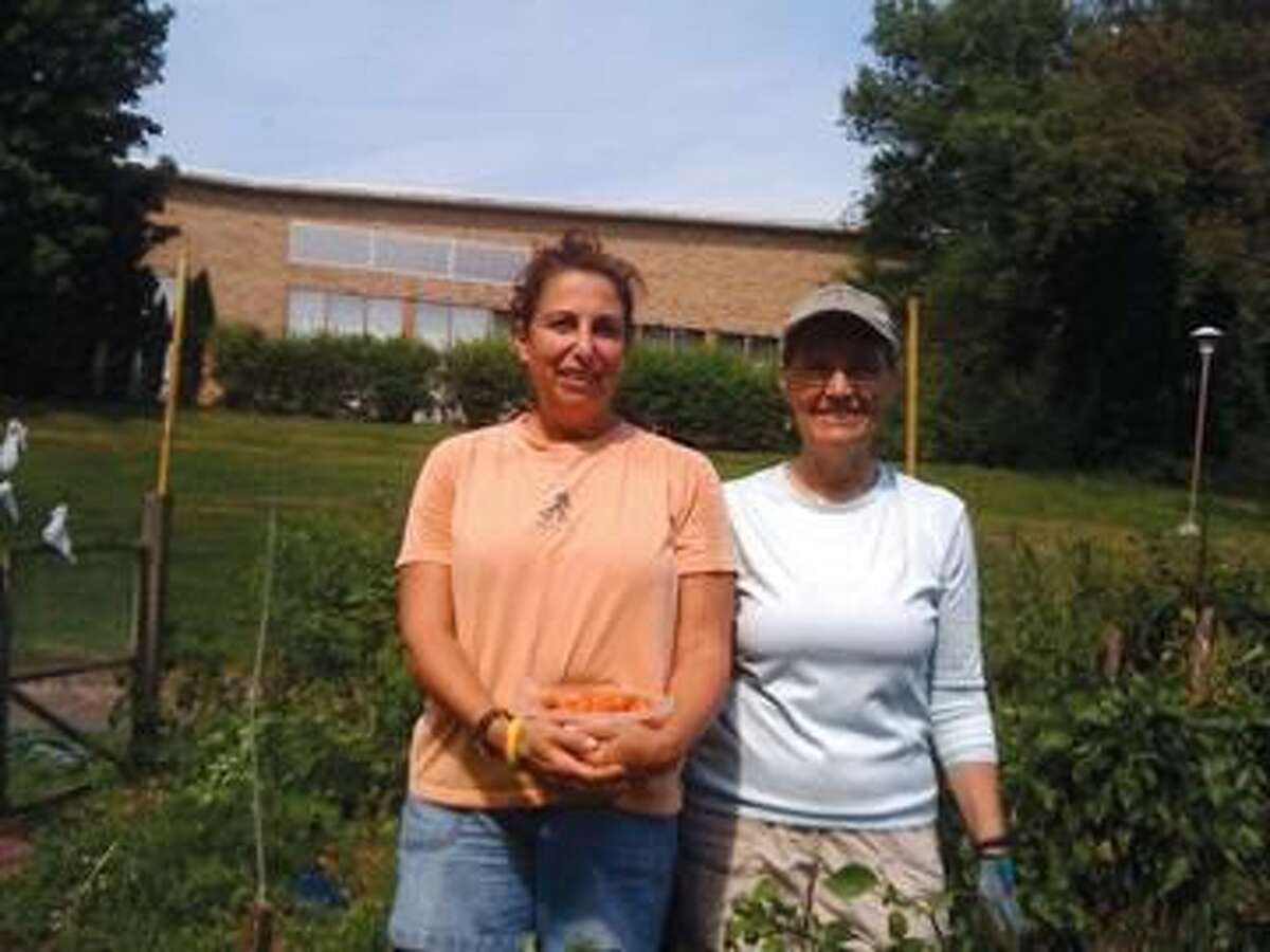 Submitted Photo The photo shows Leslie Redmond and fellow congregant, Sue McDonald, who will tell you they “love to get their hands dirty”!