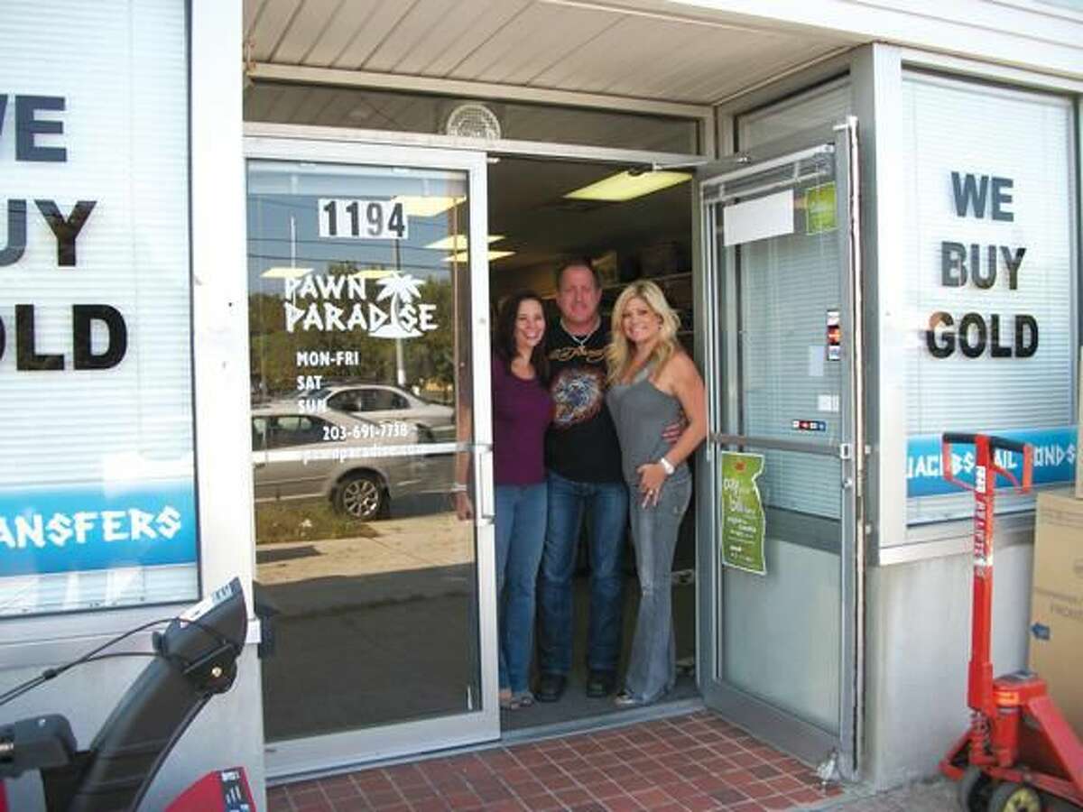 Photo by Lynn Fredricksen Tracy Hlavaty, Craig McCarthy and Krista Jacobs at the entrance to their Pawn Paradise shop where they buy, sell, trade, pawn, cash checks and provide bail bond services.