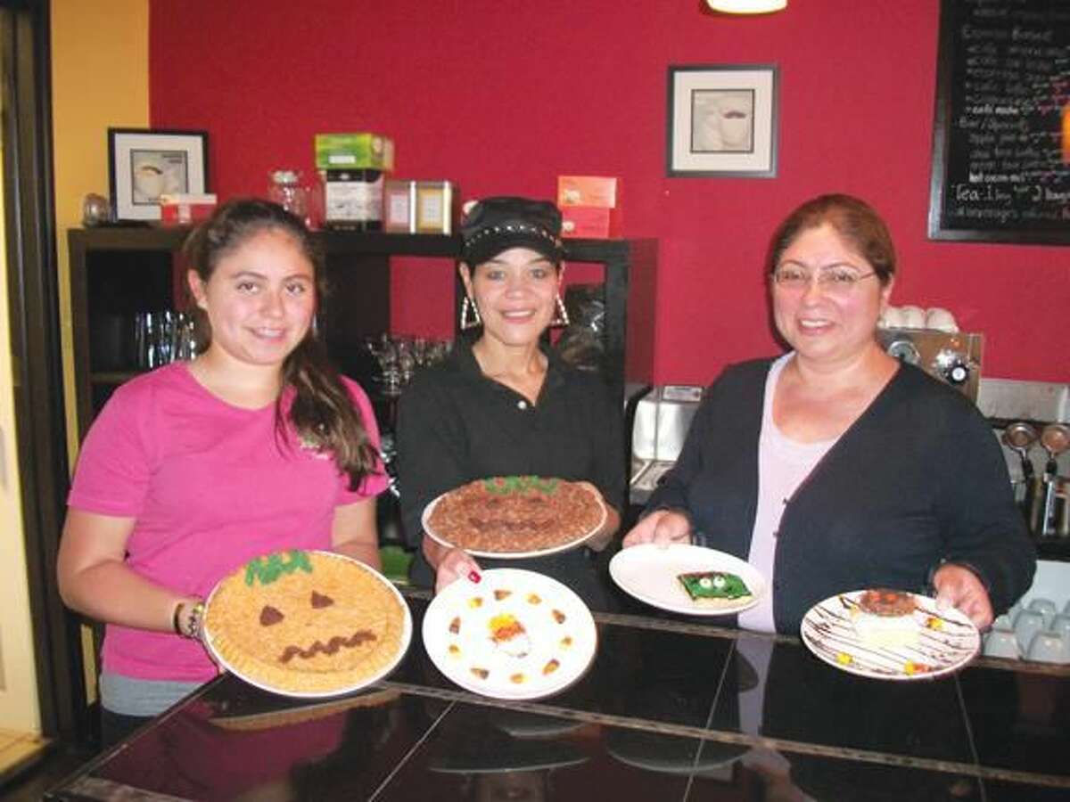 Photo by Lynn Fredricksen Diana Hart, 13, Lucy Fernandez and Ayda Hart show off some of the seasonal desserts they offer at Paola’s Gourmet Specialties & Coffee at 1830 Dixwell Avenue, across from Home Depot. The restaurant is open five days a week and serves breakfast and lunch.
