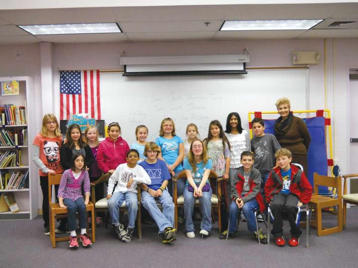 Submitted Photo Molly D’Andrea (seated in the center) meets with Mrs. Lydia Westerberg (far right) and the children in the Young Writers’ Club at Ridge Road School Elementary School in North Haven.