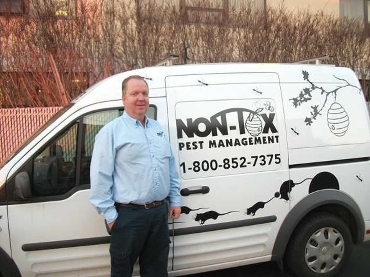 Photo by Lynn Fredricksen Bob Hannon, owner of Non-Tox Pest Management, stands by his truck decorated by one of his sons. Hannon, a long time staple in the business community, actively participates in community service and strives to give back to the community.