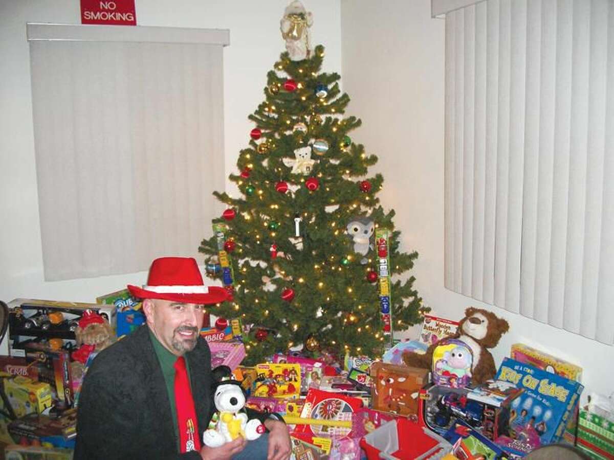 Photo by Lynn Fredricksen Dave Signore, a member of the Connecticut Valley Litho Club, checks out some of the toy donations as part of a toy drive the CVLC conducted in partnership with the Knights of Columbus. All the donations will benefit local children through the Department of Community Services.