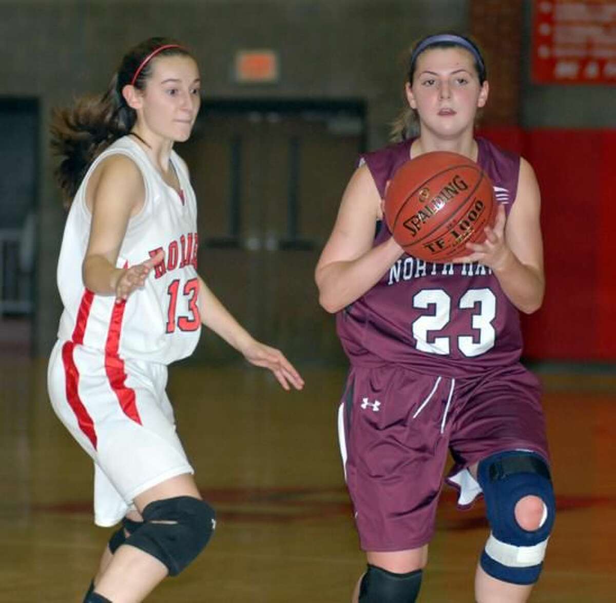 Photo by Dave Phillips North Haven's Brianne Melillo looks to pass during the Indians' 44-37 overtime loss to Branford last Friday night in Branford.