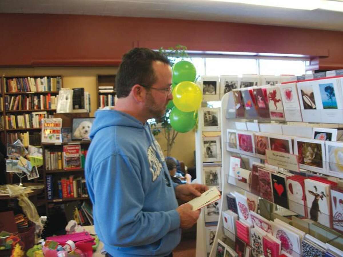 Photo by Lynn Fredricksen Hamden resident Mark Lawless shops the vast card selection at Books & Co. on Saturday. The popular spot was chosen as a Cash Mob location after a nomination process through the town’s Economic Development Corporation.