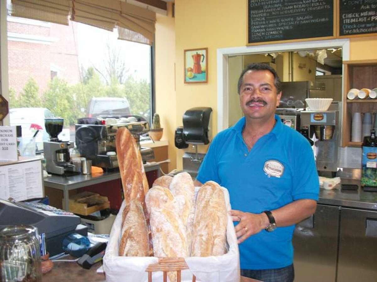Photo by Lynn Fredricksen Jaime Zapata, who owns Bread and Chocolate at 2457 Whitney Avenue in Hamden, shows off some of the artisan breads he offers for sale. Bread and Chocolate offers breakfast and lunch items as well as a variety of breads and desserts.