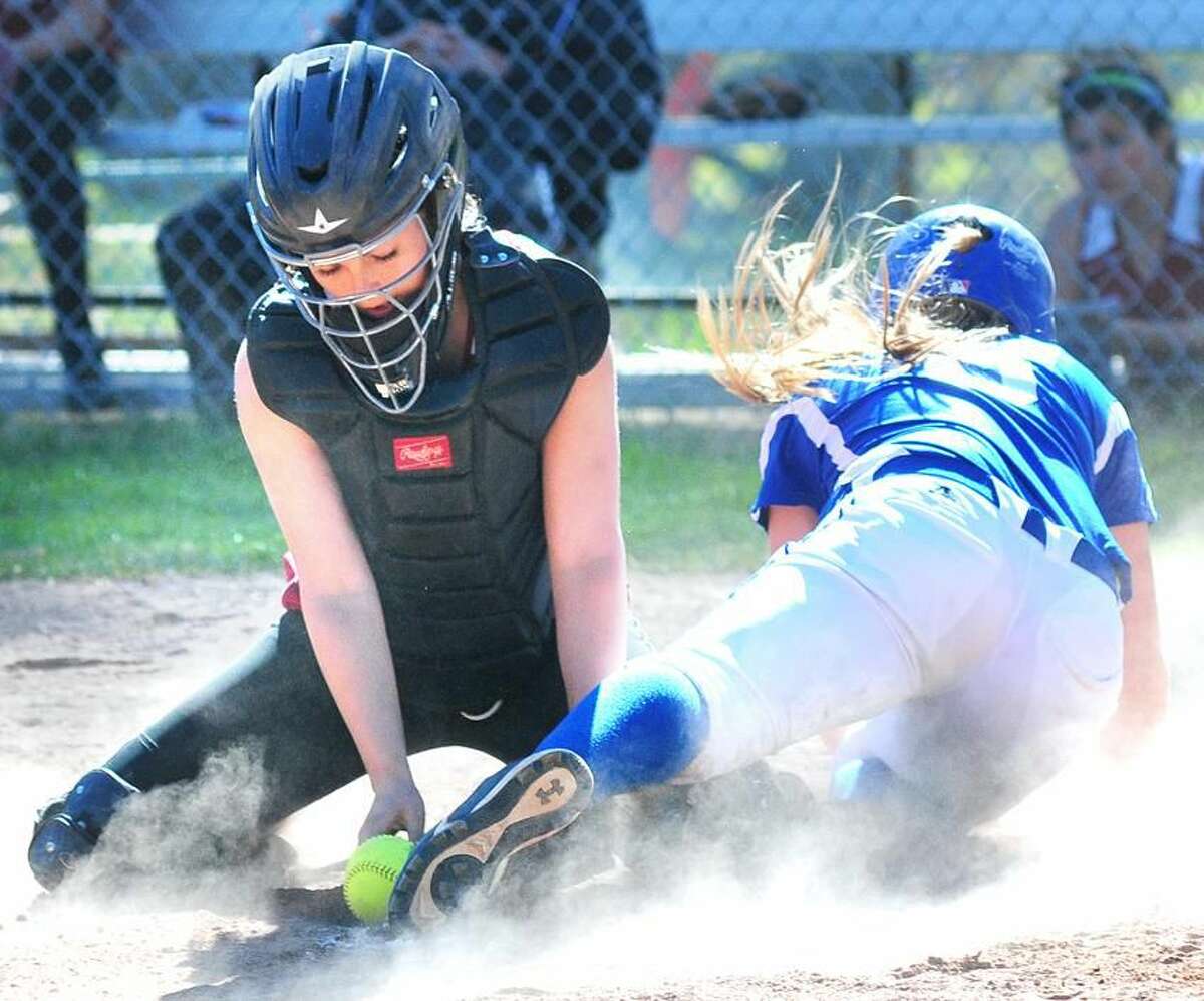 Kristen Domek of West Haven is safe at home as Sacred Heart catcher Angela Onofrio (lerft) traps the ball on the ground in the third inning in Hamden on 5/1/2013.Photo by Arnold Gold/New Haven Register