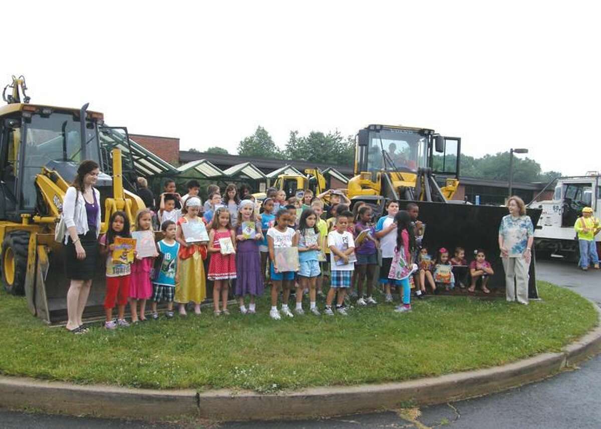 Submitted Photo Hamden’s Public Works crews turned out with their fleet of big rigs at Dunbar Hill School to kick-off Hamden Public Library’s 2013 Summer Reading program, “Dig Into Reading.” Library Director Marian Amodeo and Superintendent of School Fran Rabinowitz, Children’s Librarian Nancy McLaughlin and Quinnipiac Fellow Lucy Freeman joined school staff to greet students and explore the machines. Summer Reading runs through mid-August at all Hamden Public Libraries and is open to children of all ages. Nationally, Summer Reading programs have been proven to help students maintain their reading skills through the summer.