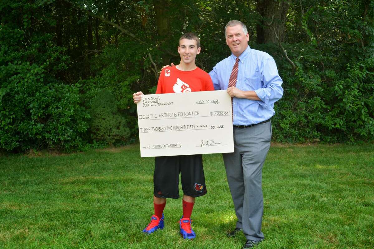 (Photo courtesy of Julie Alissi/J8 Media) Jack Diana, left, with his father Rich Diana hold up a check for $3,250 that they donated to the Arthritis Foundation. The funds were raised from a four-day junk ball tournament.
