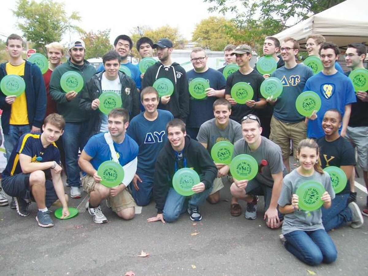Submitted Photo Members of Quinnipiac University’s Delta Upsilon Fraternity at Hamden’s recent Multicultural Festival, joined HYAC’s “Positive Choices” Committee to convey the message, “Fly Above the Influence.” Delta Upsilon members, along with Committee members, gave frisbees imprinted with that important message to younger attendees at the event.