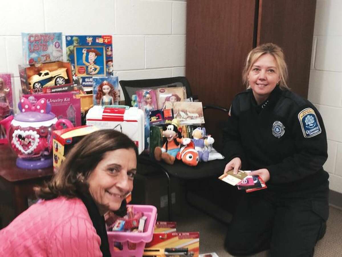 Submitted Photo Patricia Polvani (left), a secretary in the Department of Public Safety at Quinnipiac University, and Shanon Grasso, a public safety officer, have helped organize a ‘Ticket for a Toy’ drive to benefit Hamden children. Those who donate a toy, gift certificate, gift card or movie pass with a value of at least $10 will have one unpaid parking ticket expunged from their record at Quinnipiac.