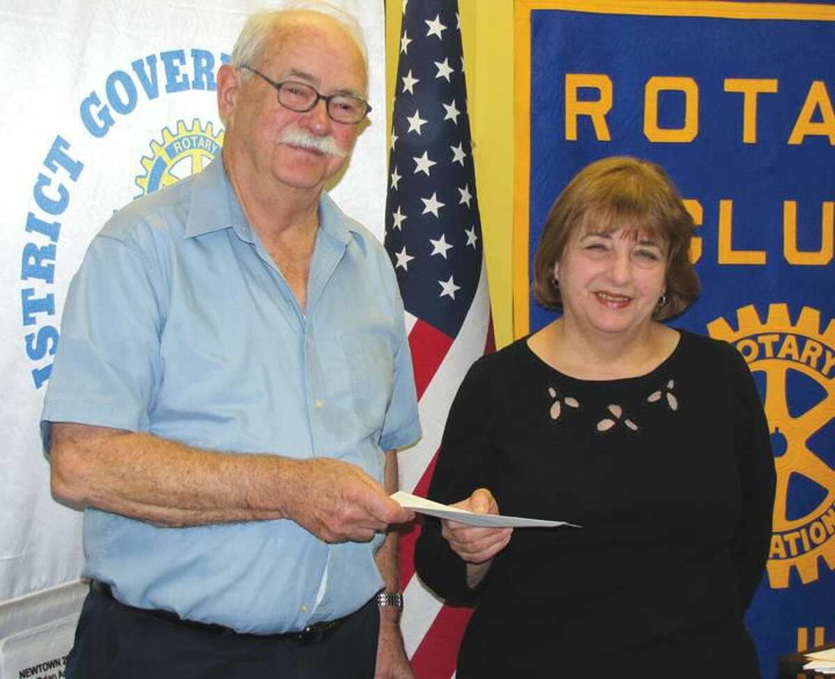 Photo courtesy of David Marchesseault & George Guertin, Rotary Publicity Committee North Haven Library Director Lois Baldini accepted this year’s donation for the Rotary Career Corner from John Henry Graef, Jr.