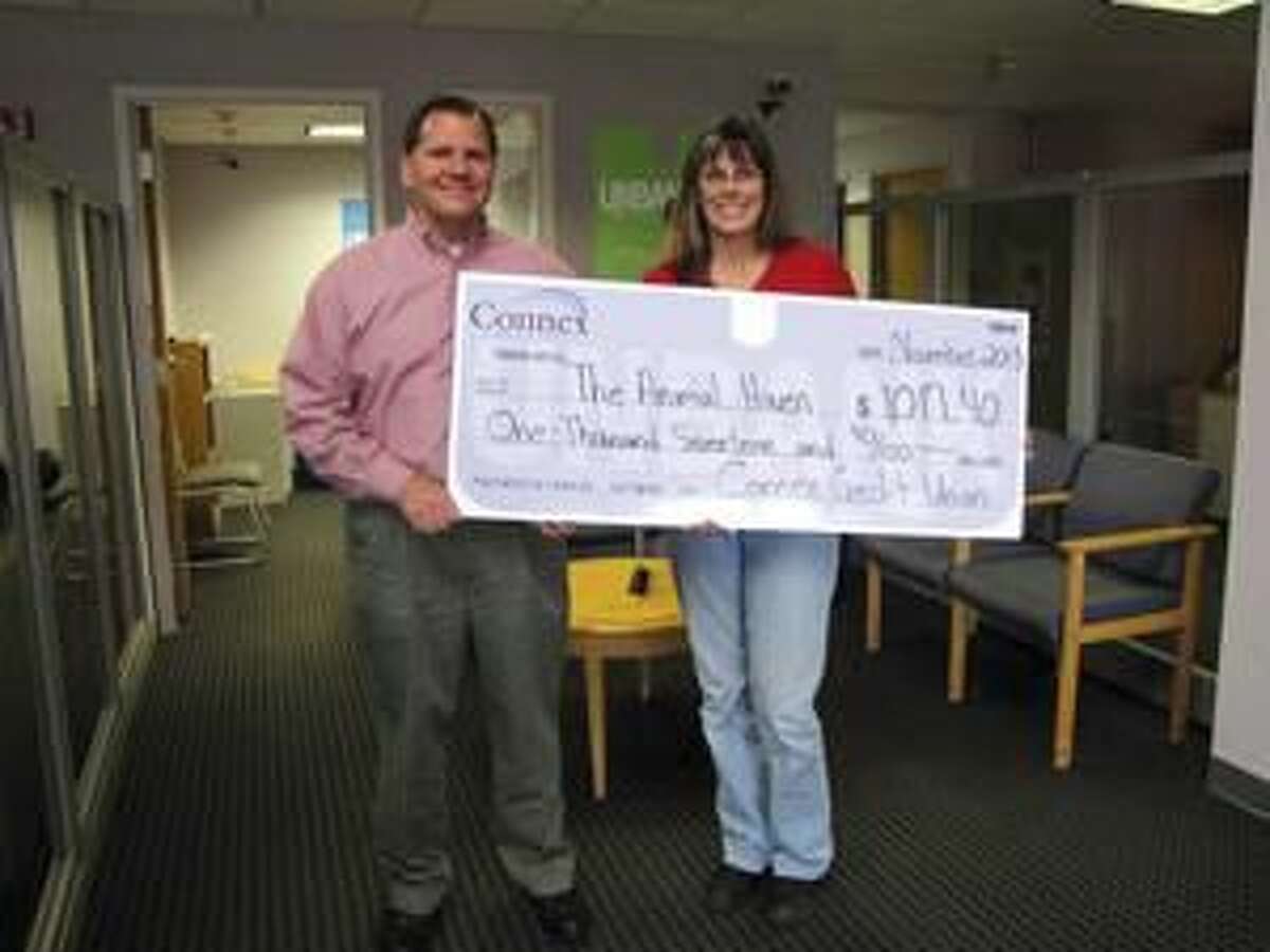 Submitted Photo Carl Casper, Connex VP of Customer Advocacy, left, presents a check to Kate Cryder, Animal Haven Manager.
