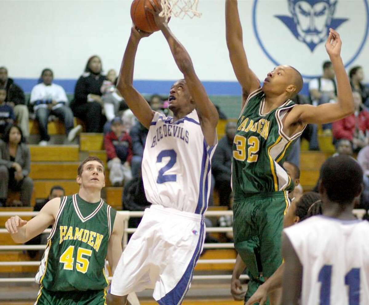 West Haven's Gary Williams goes to the basket while Ryen Vilmont (32) defends and Alex DeMarco (45) looks on. (Photo by Russ McCreven)