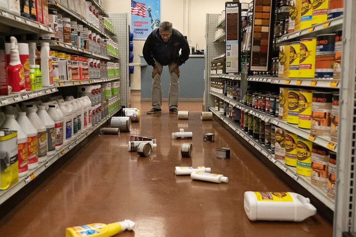 Barry Craig, looks at fallen paint cans at Dunn-Edwards Paints on Tuesday, Oct. 15, 2019, in Pleasant Hill, Calif.