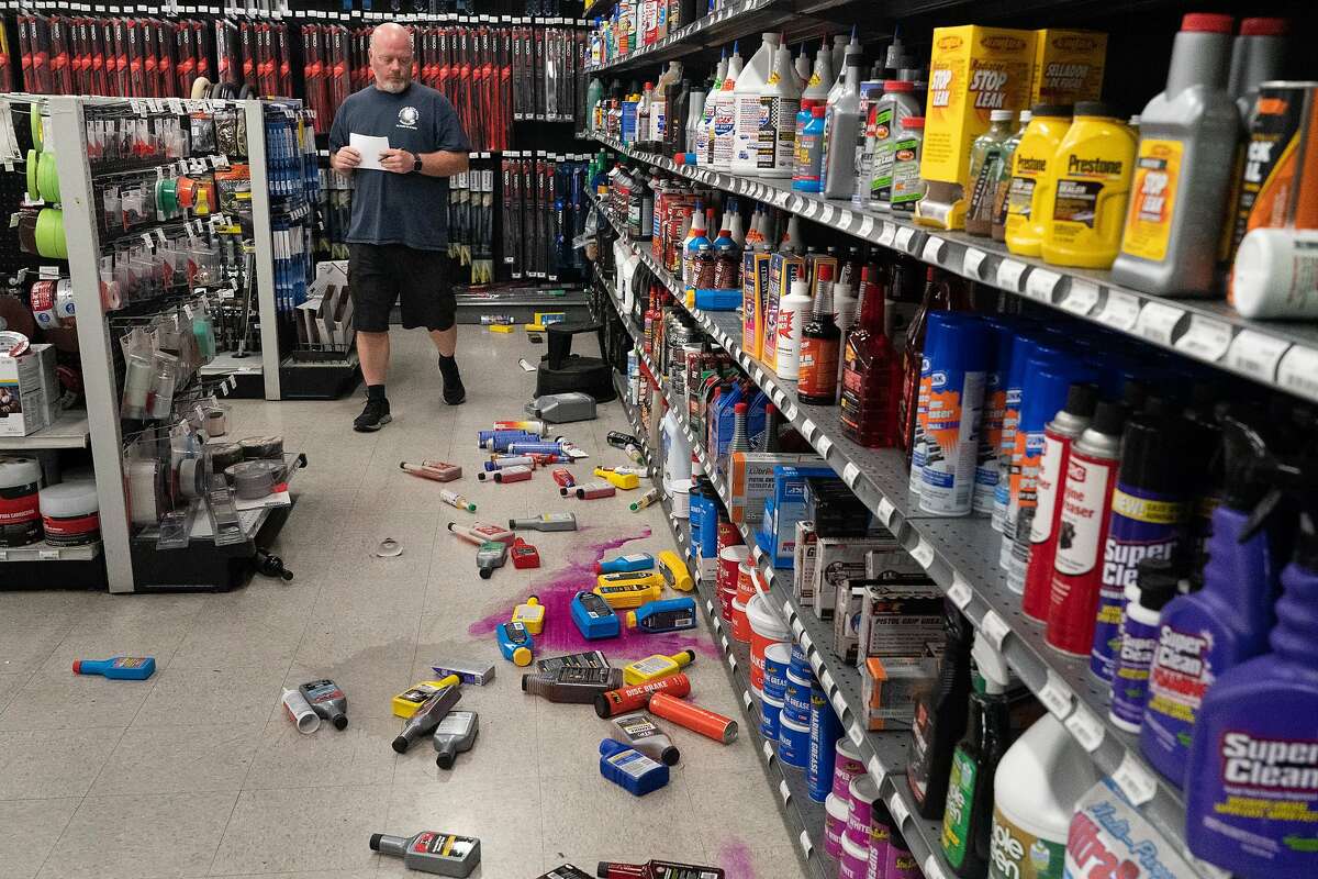 Brian Maloney, warehouse manager at Monument Car Parts looks at fallen merchandise on Tuesday, Oct. 15, 2019, in Pleasant Hill, Calif.