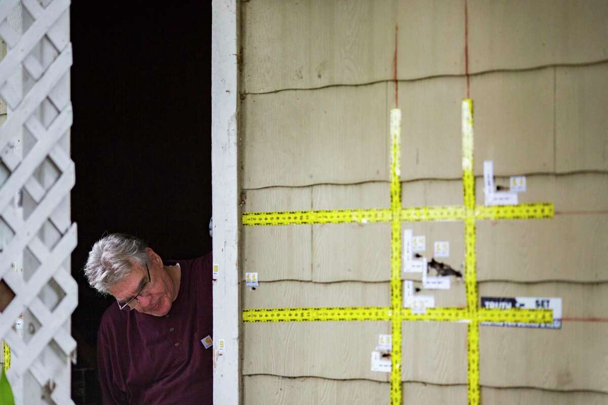 An out-of-state forensic analyst brought in by the family of a couple killed in a botched drug raid examines bullet holes on 7815 Harding on Friday, May 10, 2019, in Houston. The home was the scene of a botched drug raid that took place on Jan. 28, 2019 and left the two homeowners dead and five police officers injured.