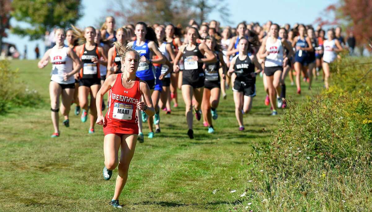 Greenwich’s Mari Noble leads competitors at the start of the FCIAC girls Cross Country championship meet at Waveny Park in New Canaan on Tuesday. Noble went on to win the race, placing first with a personal best-time of 14:06.