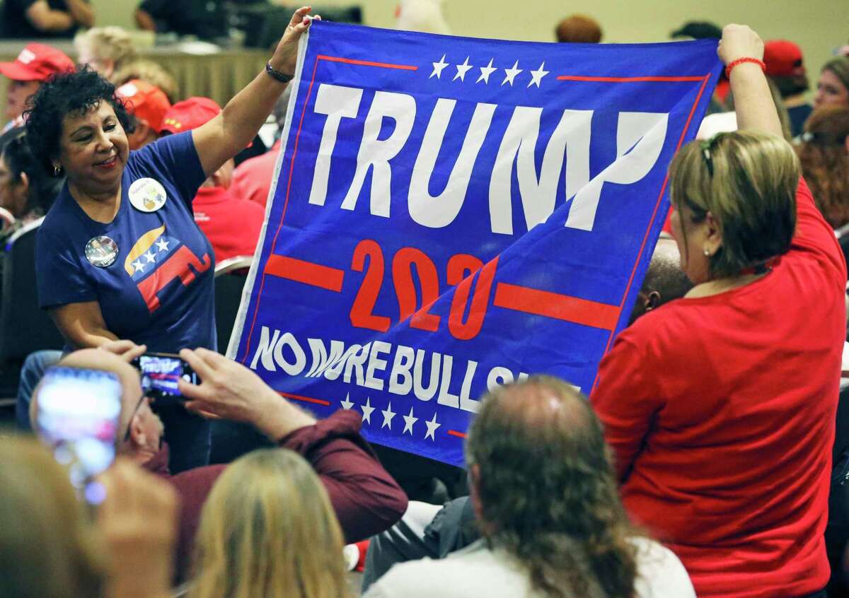 Eva Mickler,left, and Esther Brant parade a banner as Donald Trump, Jr. visits the Henry B. Gonzalez Convention Center on behalf of the Trump/Pence 2020 rel-election campaign on Oct. 15, 2019.