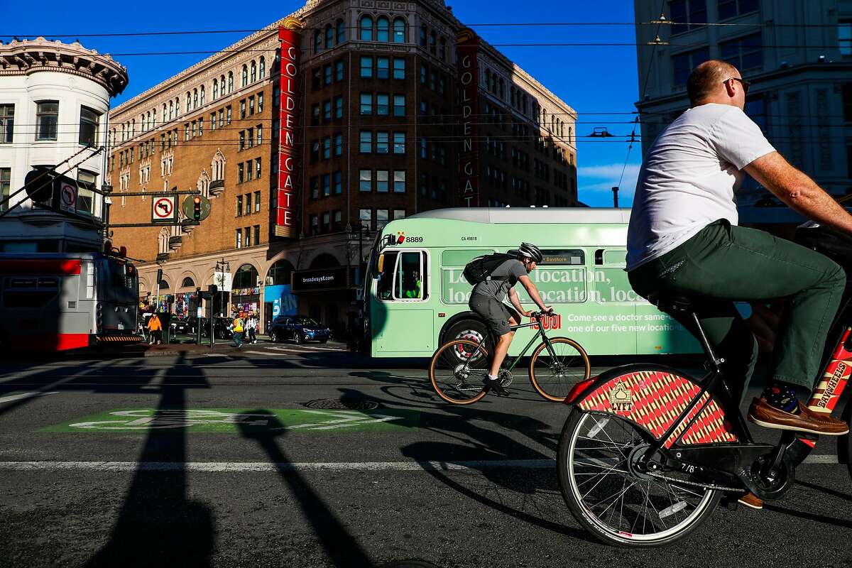 Commuters ride their bikes down Market Street in San Francisco, California, on Monday, Oct. 7, 2019.